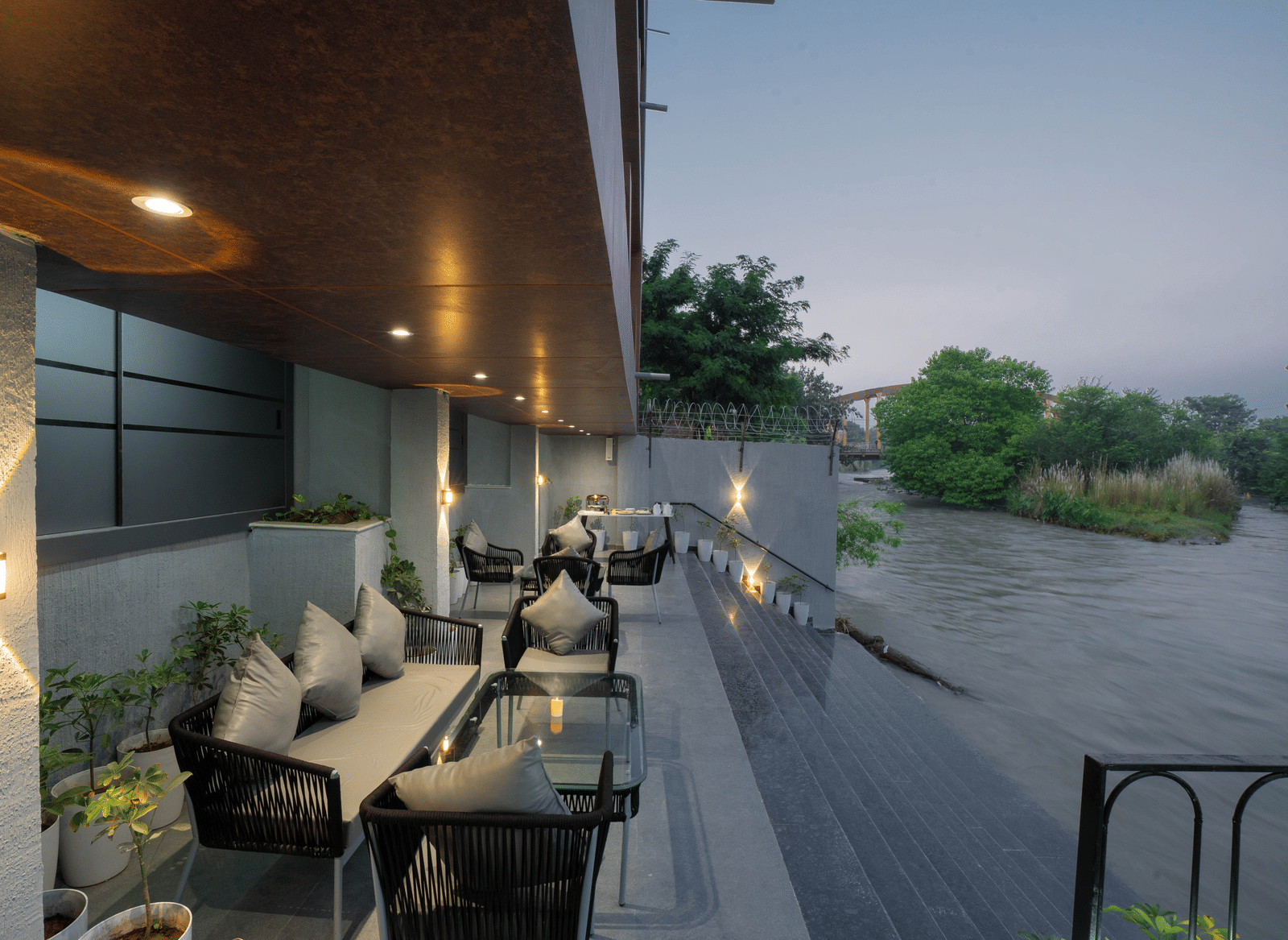 Comfortable outdoor seating area overlooking the river, perfect for relaxing at Sukoon by the Ganges.
