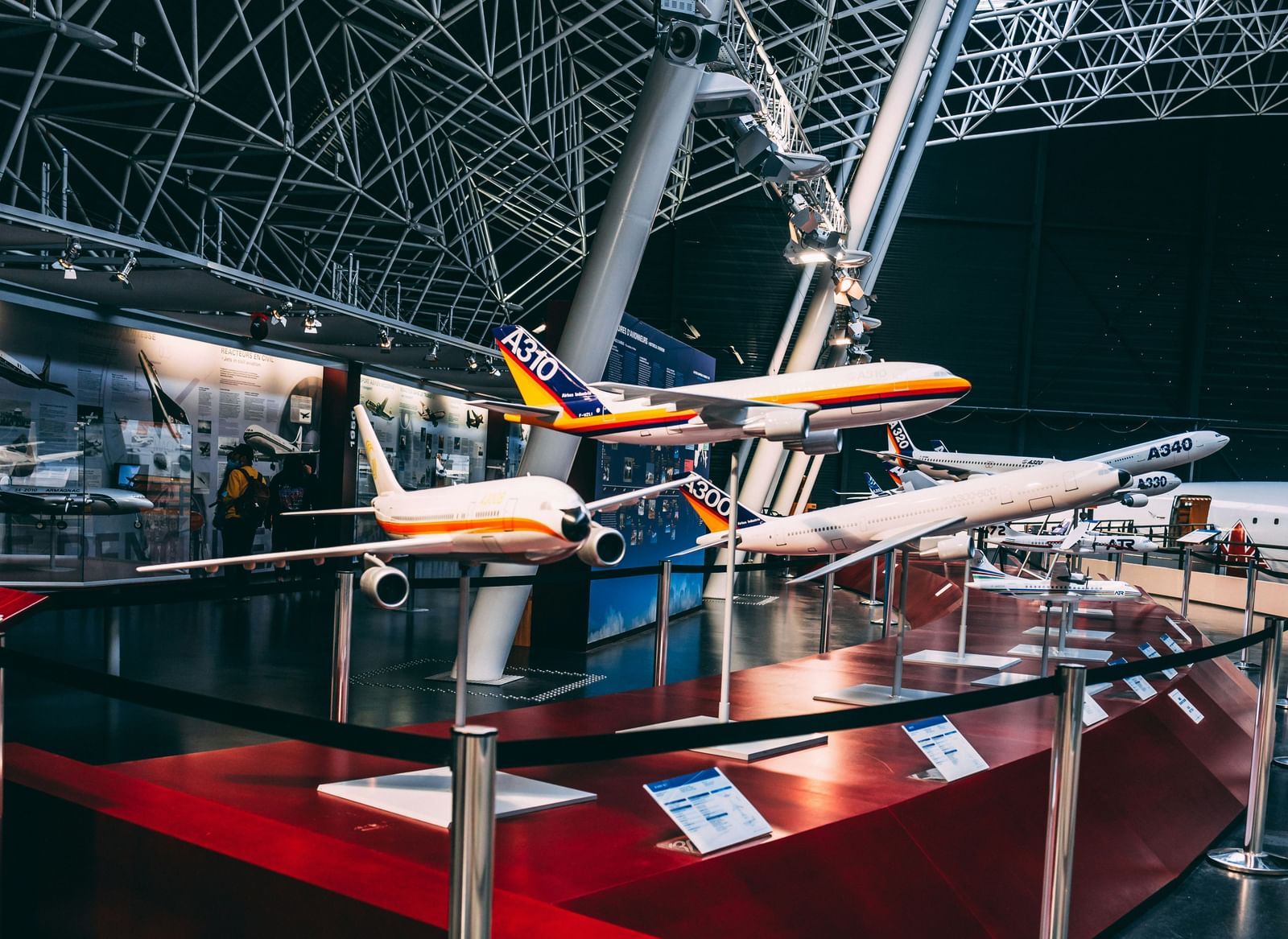 A display of multiple airplane models inside an aviation museum.