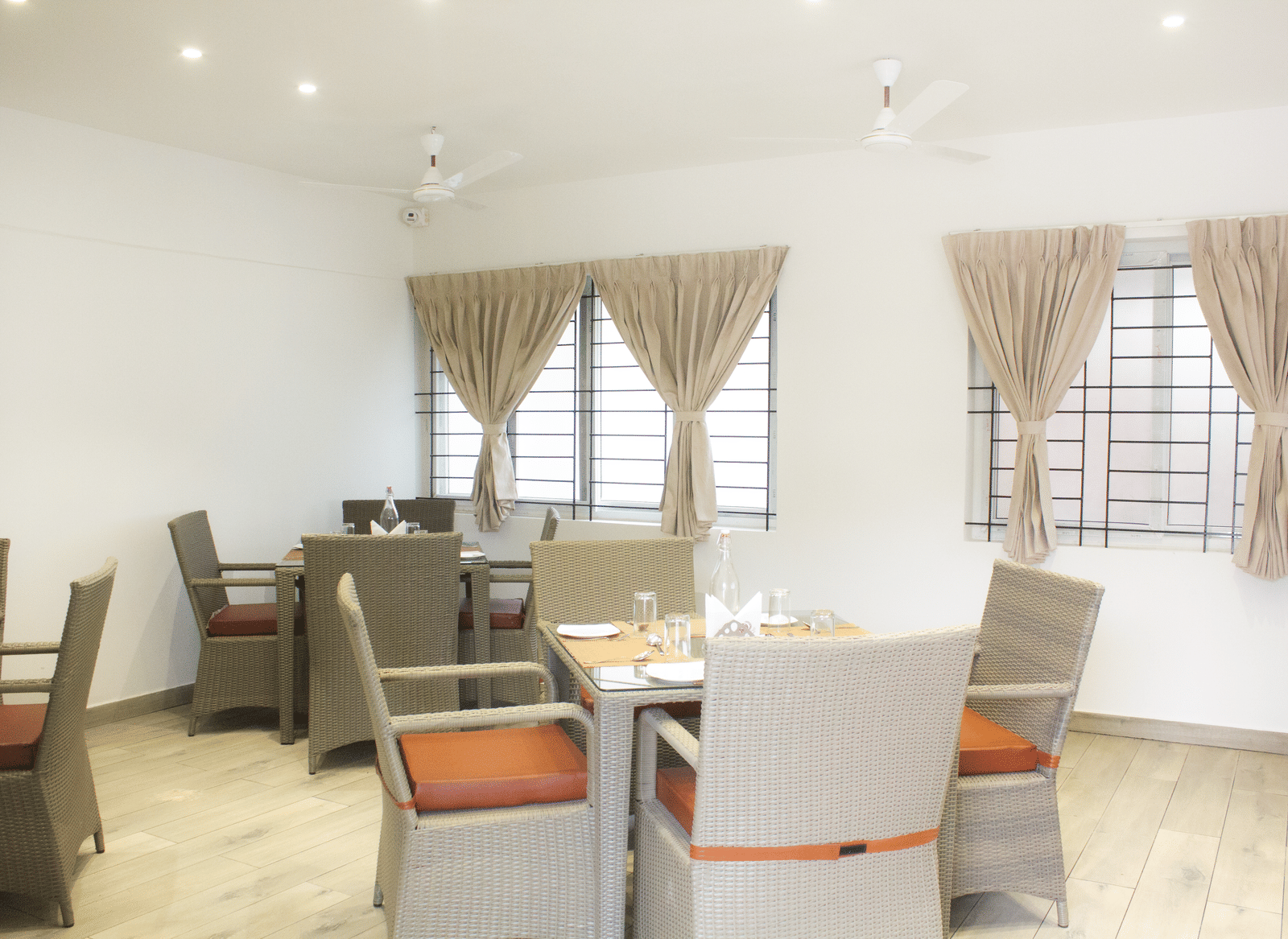 A full-view shot of the Spice and Slice Restaurant with well-arranged dining tables at WOW Naturefull Resorts, Yercaud.