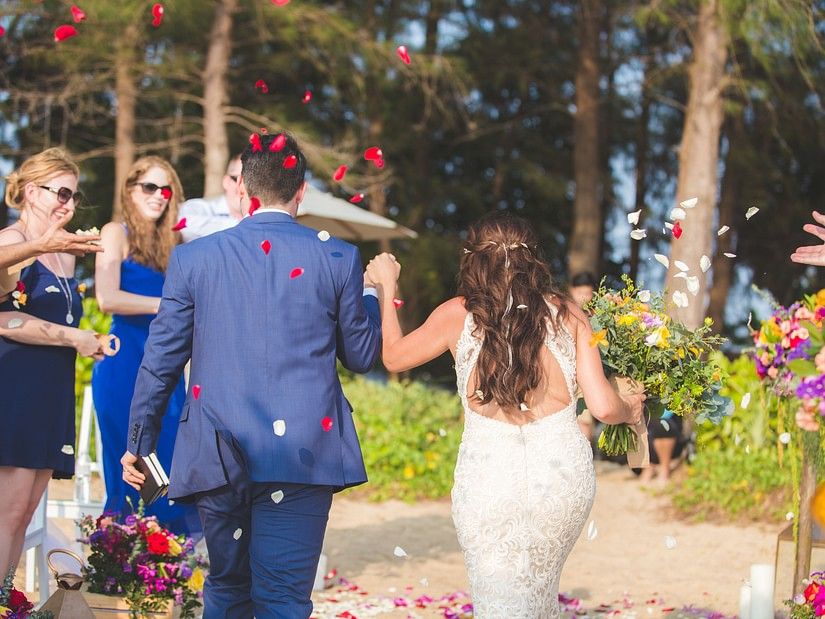 back shot featuring the couple holding hands walking towards the guests - Maikhao Dream Villa Resort & Spa, Phuket