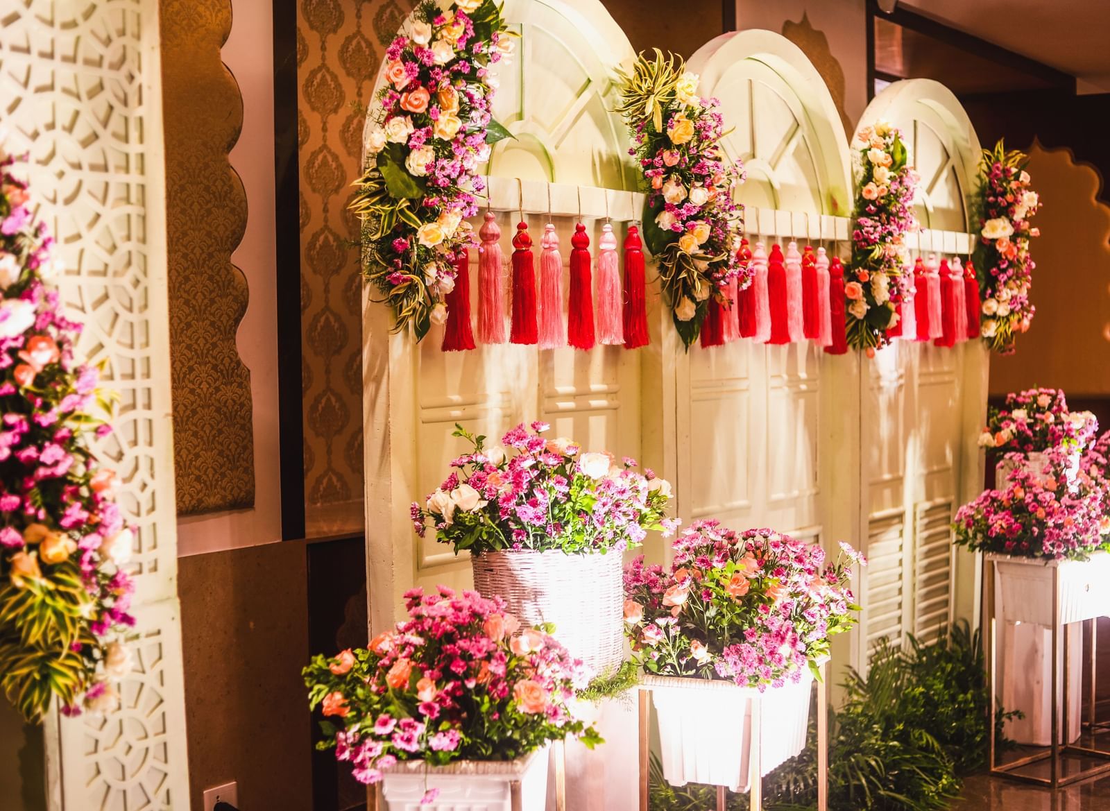 A cosy corner filled with potted plants, walls with ornamental flowers and an arch - Kaldan Samudhra Palace