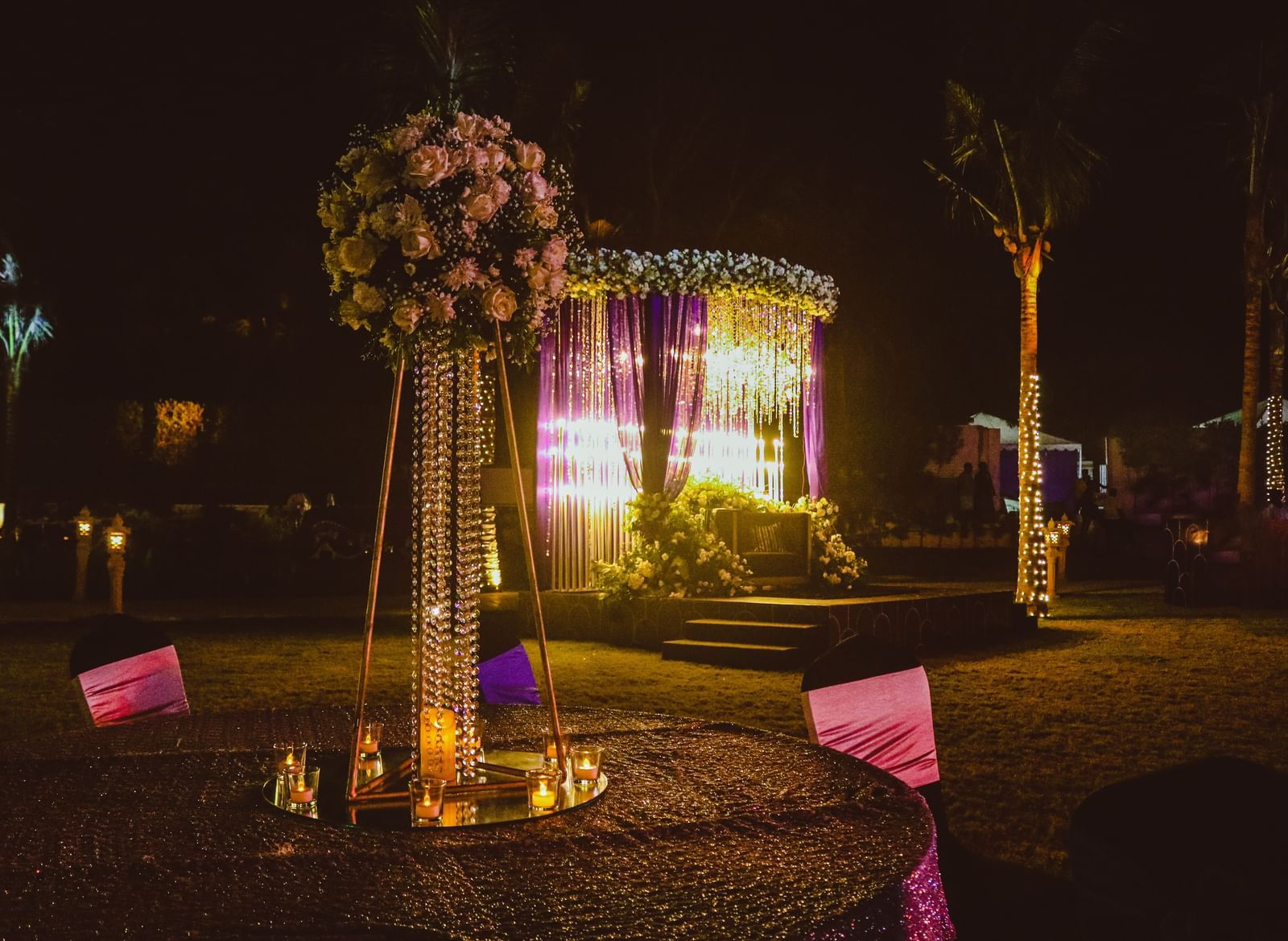 a mandap in the lawn of Kaldan Samudhra Palace featuring a table with a bouquet of roses