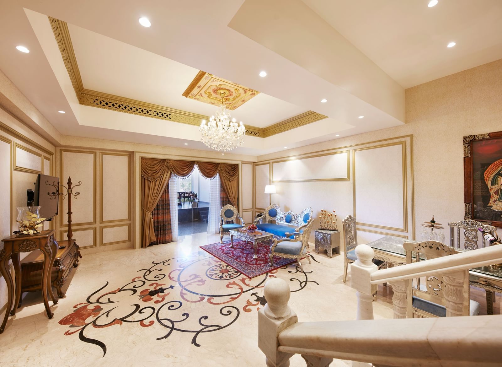 A grand living area with a colourful rug and sophisticated beige furniture - Kaldan Samudhra