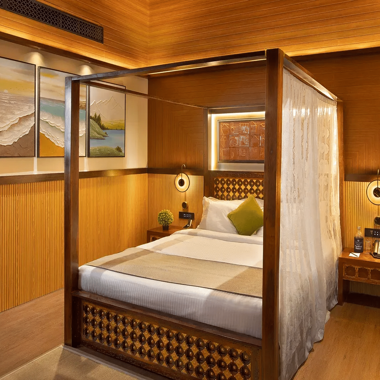 Coral Teal Suite at Coral Reef Resort and Spa in Havelock featuring a plush canopy bed with a nightstand next to it and a lamp over it