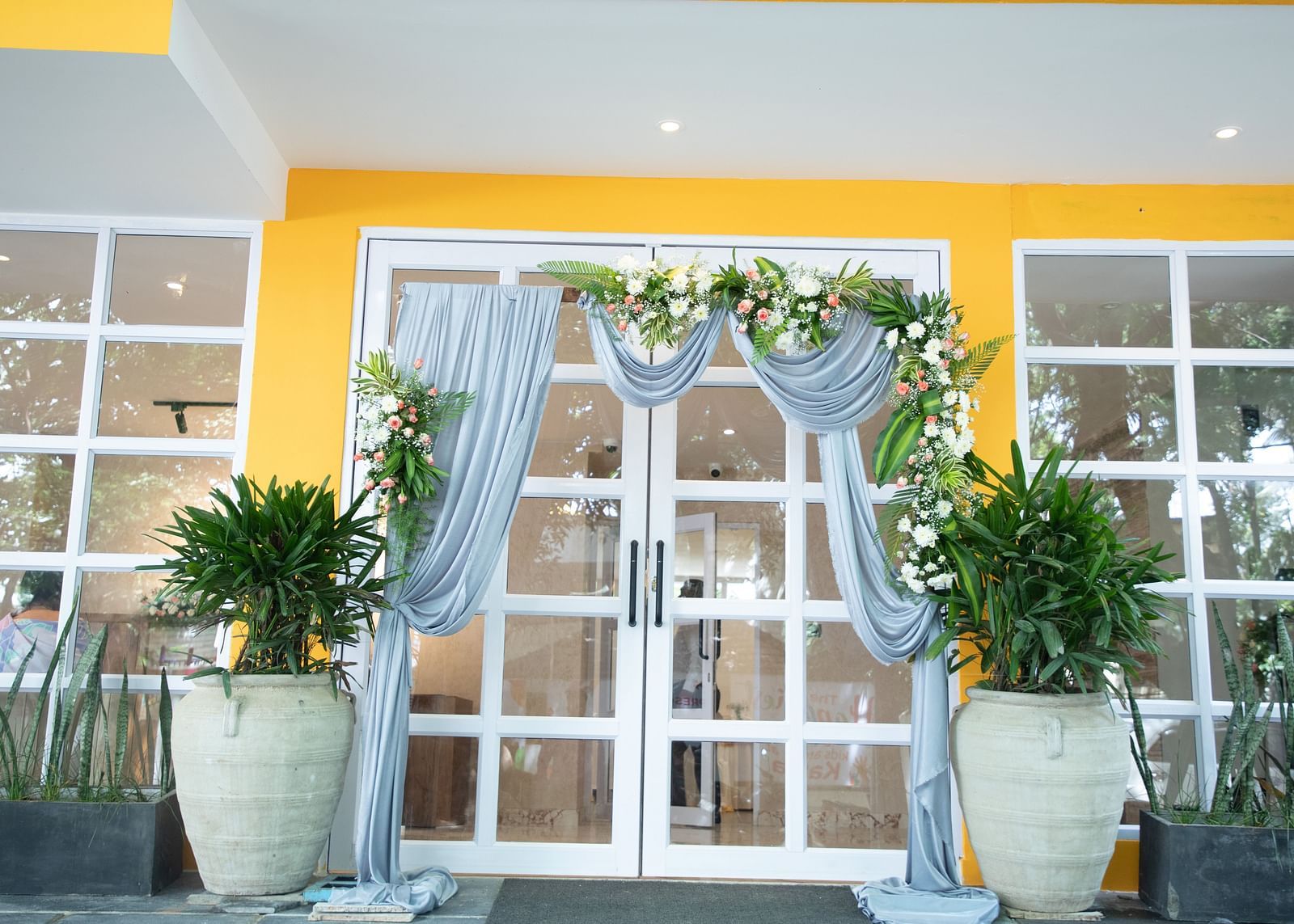 the entrace of Astra Hotels and Suites in Koramangala decorated with drapes and flowers