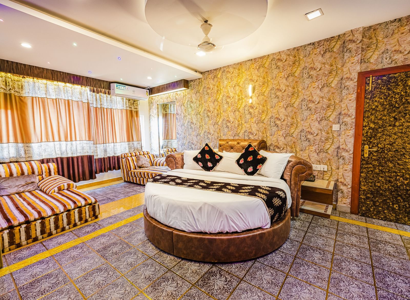 A round bed and sofa in the Jacuzzi Family Room at Parakkat Nature Hotel and Resorts Munnar 2
