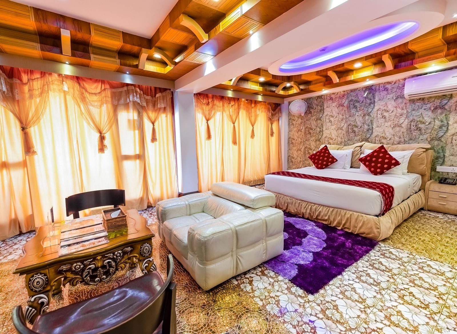 Living area and king size bed in the Presidential Suite at Parakkat Nature Hotel and Resorts Munnar 5