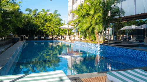 A crystal-clear swimming pool with a tranquil atmosphere at Neelkanth Sarovar Premiere Lusaka