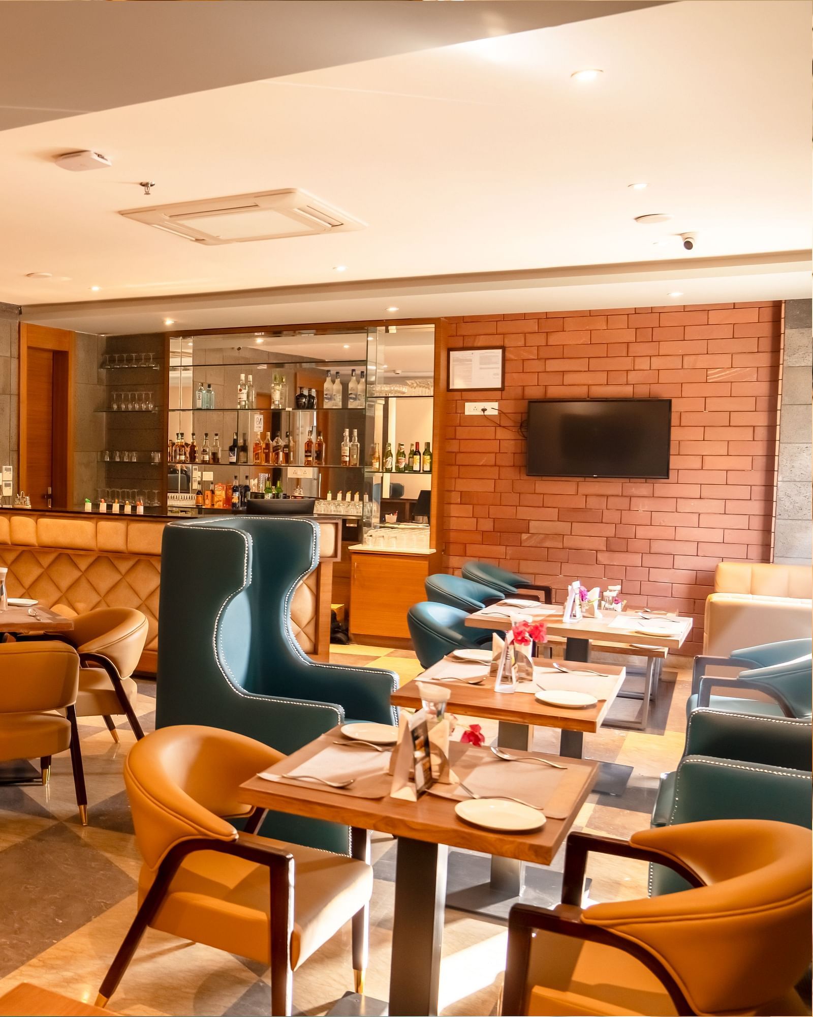 The Lords Inn Udaipur features a stylish dining area with a bar, comfortable seating, and modern decor.