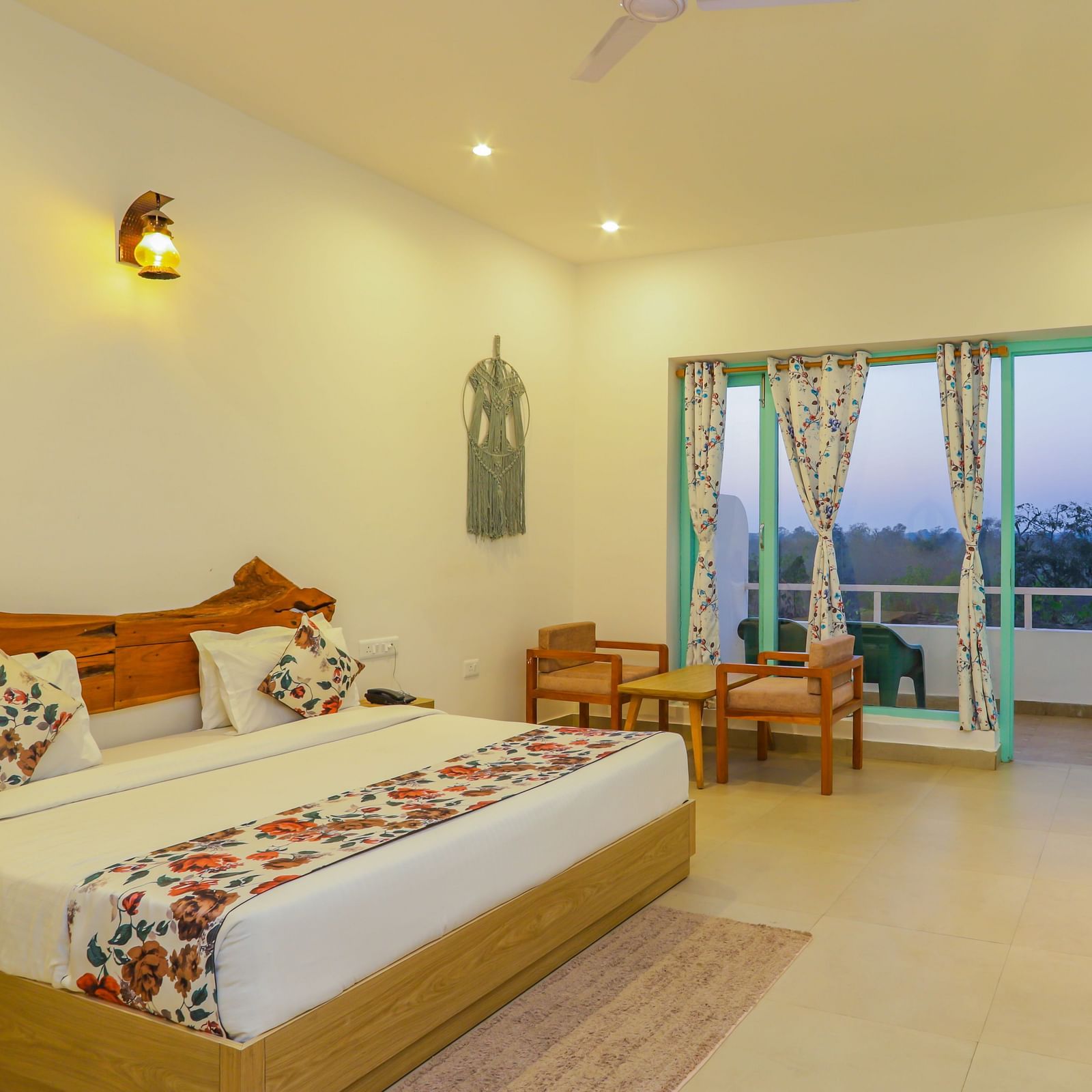 A comfortable bedroom at Vedikant Resorts The Mallard Corbett offers a bed, seating, and access to a balcony.