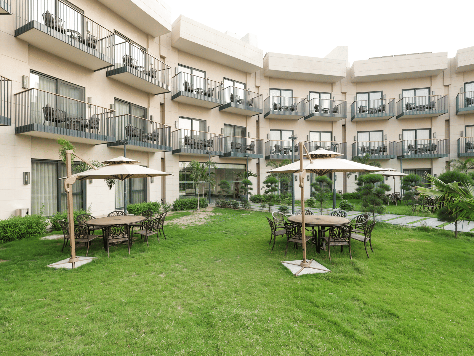 Green garden area with cabana-style seating at Ramada by Wyndham Sonipat Murthal