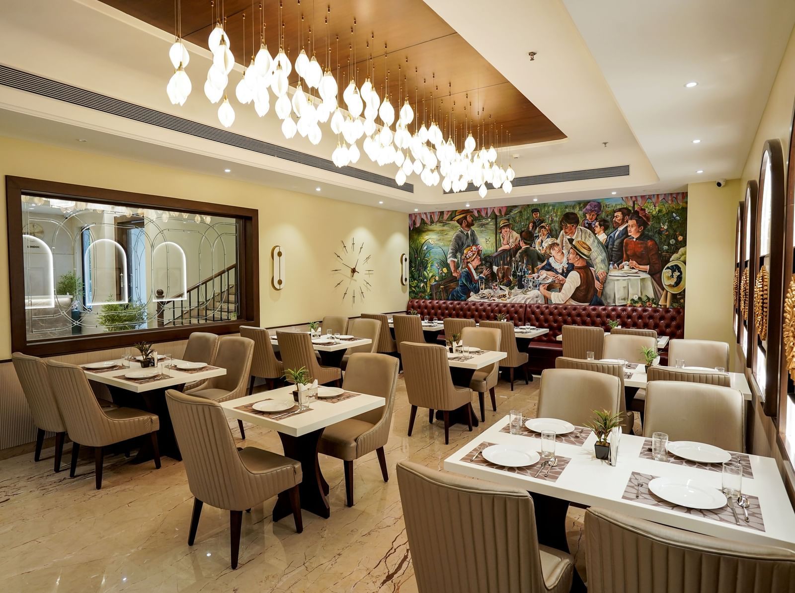 A wide angle shot of the Mosaic restaurant featuring a brightly lit dining area with modern interiors and well arranged tables at M2 Square by Monday Premium.