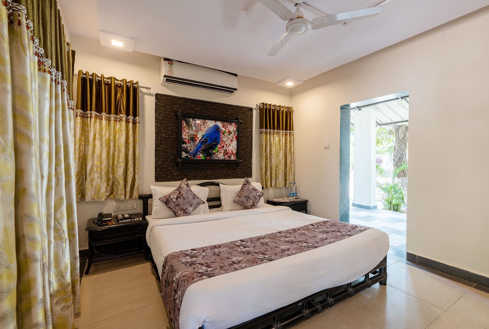 A room with with a double bed and side tables at Saavaj Resort