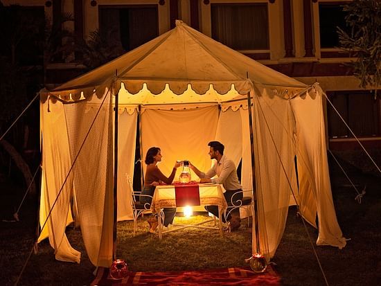 Ummed Hotels - Guests enjoying a romantic candle light dinner in a tent