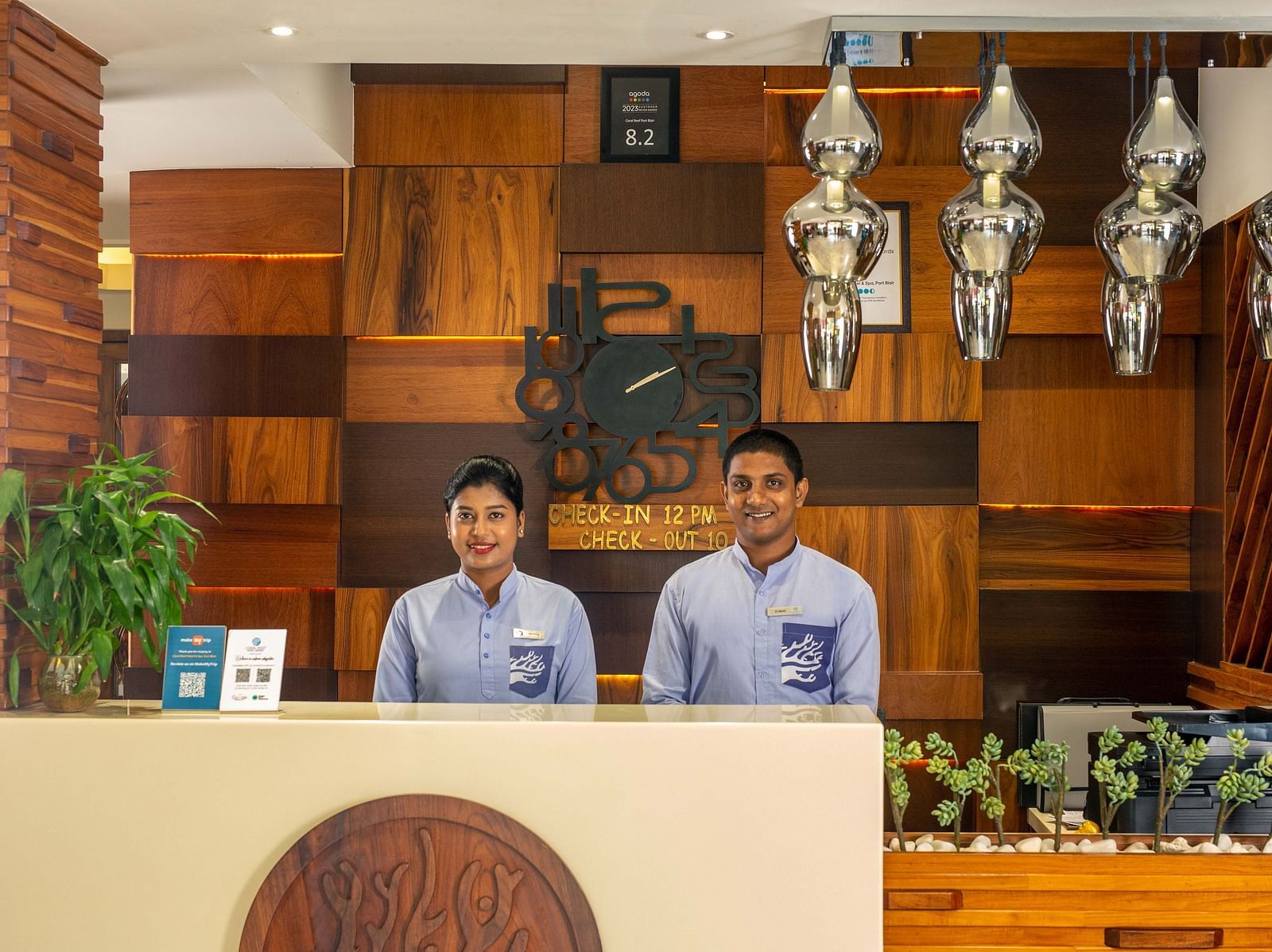 Image of two receptionists at the reception desk of Coral Reef Hotel and Spa in Port Blair