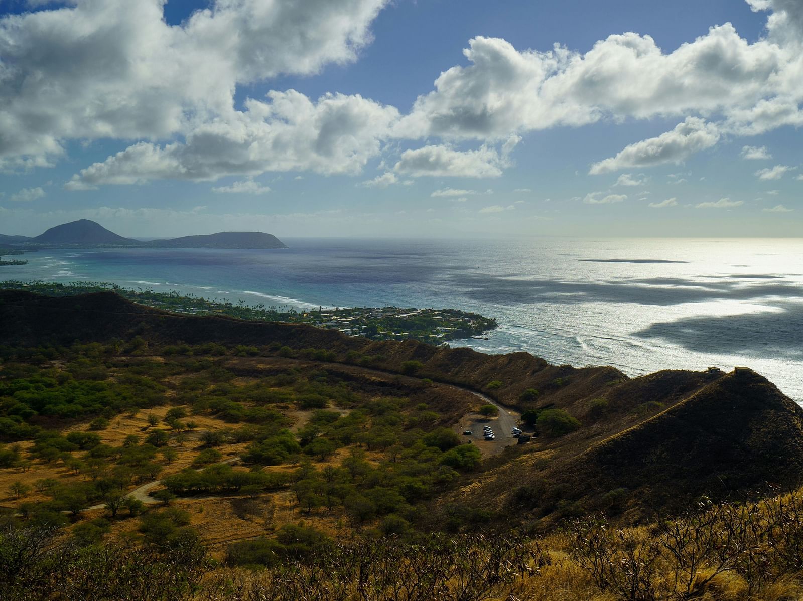 A serene view of a cliff near a water body on a cloudy day
