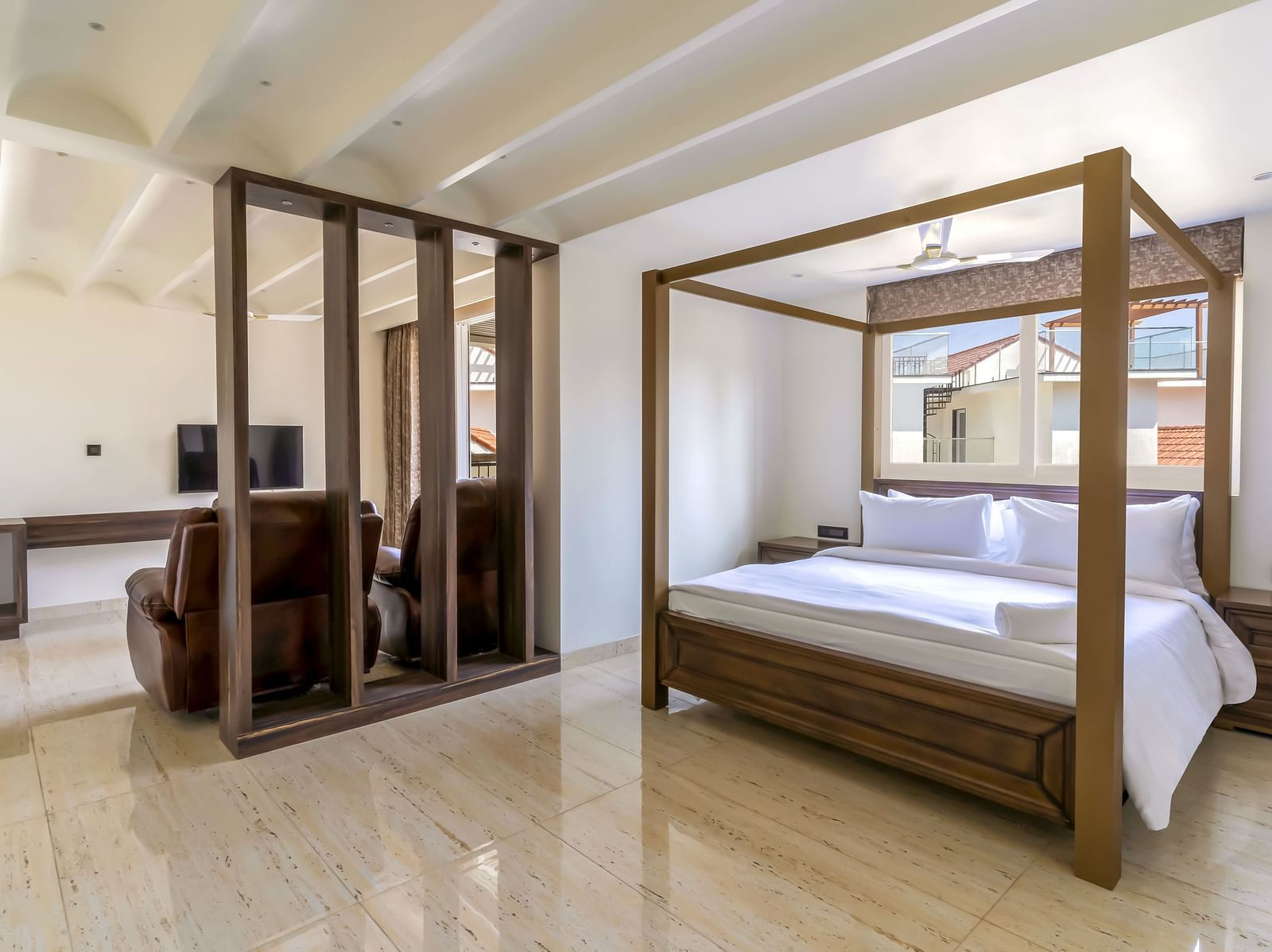 A double bed with wooden beams inside one of the rooms - The Tanisi Hotels & Resorts, Goa