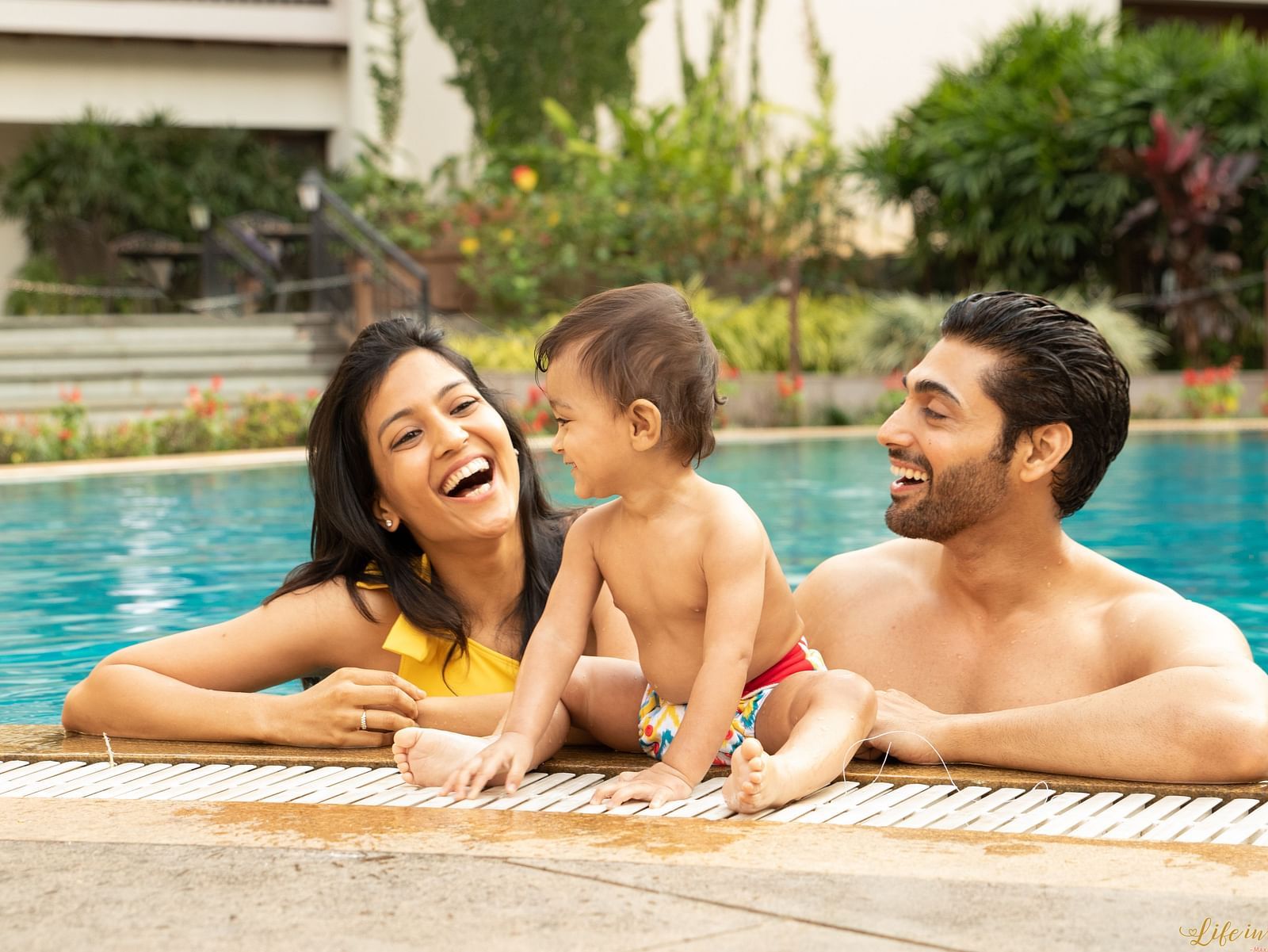 an image of a Parent and kid enjoying the swimming pool