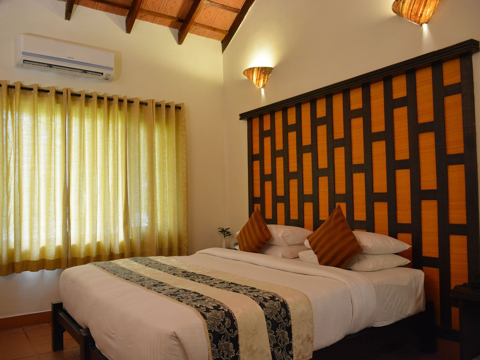 view of a bedroom with a large bed and windows covered with curtains - Kadkani River Resort, Coorg