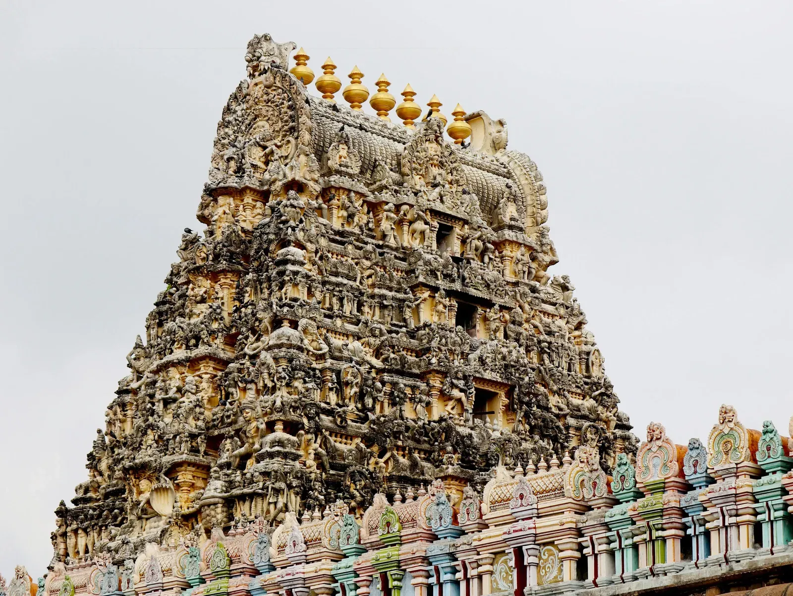 A towering, intricately carved stone temple reaching towards a light sky.