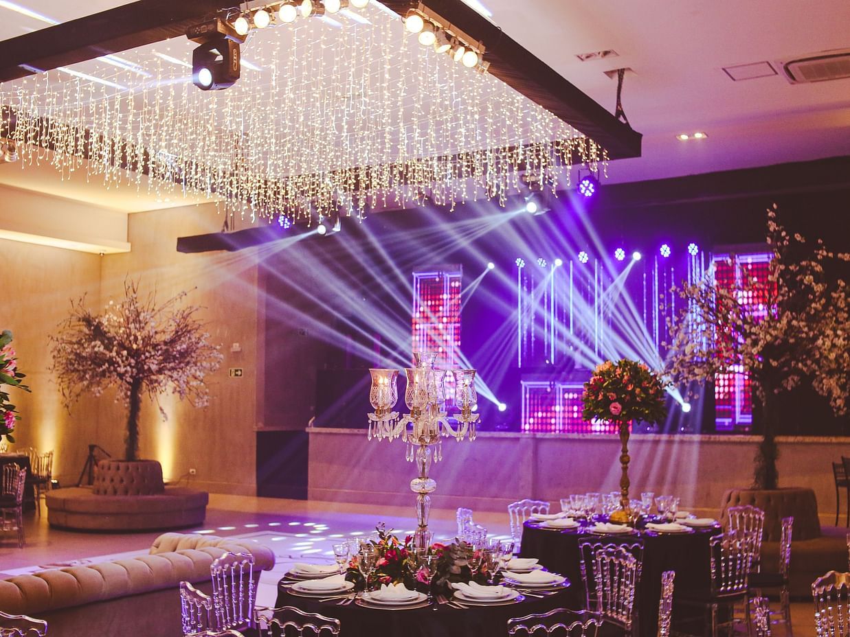 A banquet hall with a large chandelier and disco lights