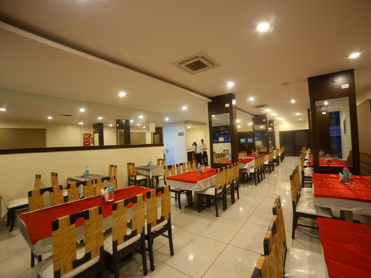A restaurant consisting of a bunch of chairs and tables - Mysore Gate Hotel Bangalore