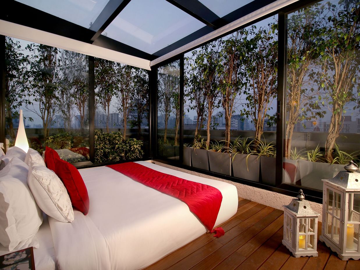 a cosy bedroom with glass windows