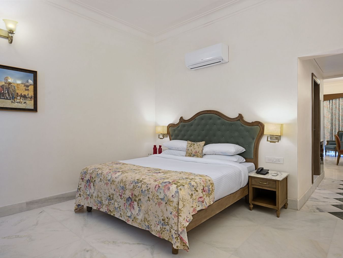 Fateh Vilas Udaipur - Interior view of the Family Plunge Suite featuring a king size bed an air conditioner and marble flooring