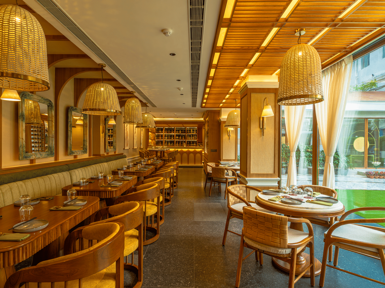 Elegant Vietnamese style dining area at Kenilworth Hotel, Kolkata, featuring warm lighting, wooden interiors, and a cosy, inviting ambience.
