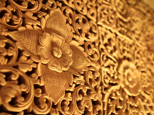Wooden tiles with intricate carvings of motifs and leaves carved on them