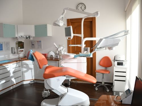 an overview of a dentist's office with the chair and other equipment