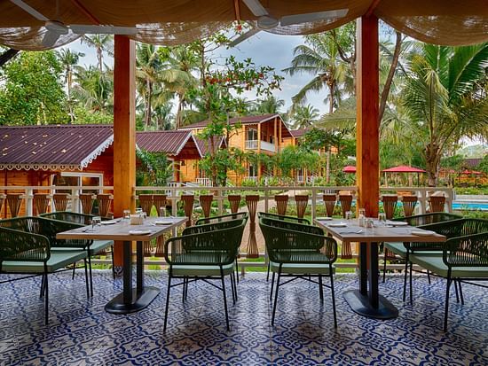 Another angle of the dining area with a focus on the patterned tile floor and the view of the tropical resort setting Aralea Beach Resort by Stone Wood, Morjim