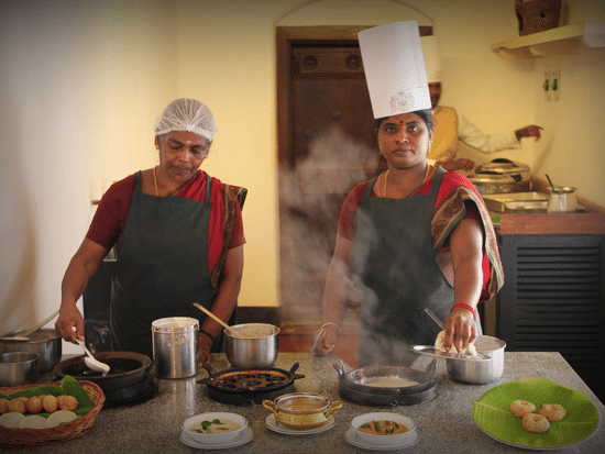 Two cooks conducting a cooking workshop at Chidambara Vilas while making Chettinad Indian Cuisine.