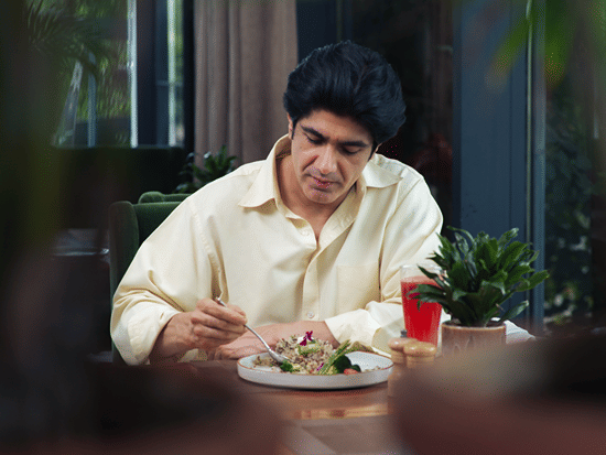 A man eating a healthy meal at Karma Lakelands.