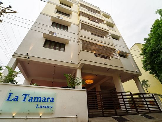 Facade view of La Tamara Luxury, Pondicherry with a tree next to it