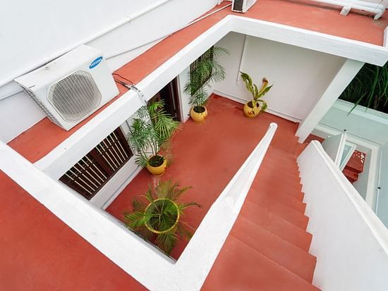 The steps from the terrace leading down to the villa covered in red oxide - La Villa Heritage, Pondicherry