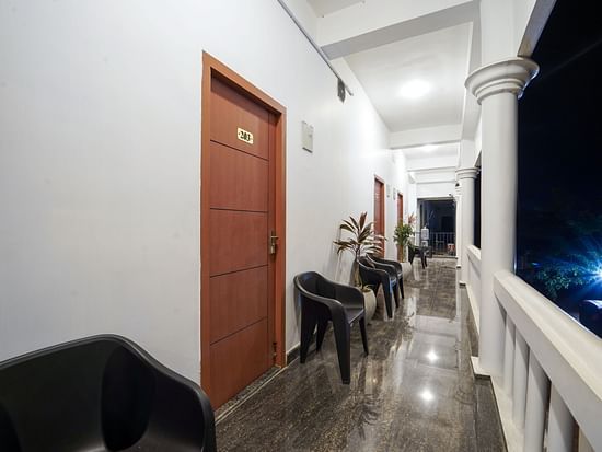 The balcony in front of the rooms with chairs next to the entrance at Le Poshe Beachview Pondicherry