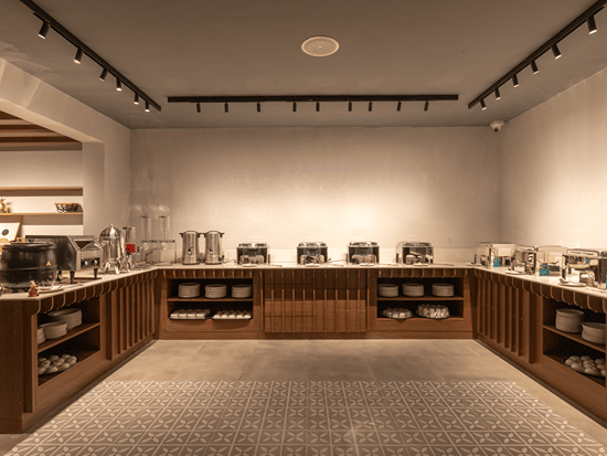 Buffet spread counter and dining setup in the multi-cuisine restaurant at Sibaya Courtyard By Stone Wood Premier.