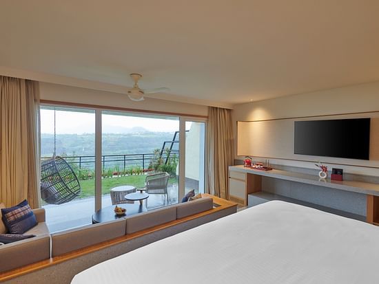  Image of a room with a king size bed and a seating area outside overlooking the valley at The Dukes Retreat.