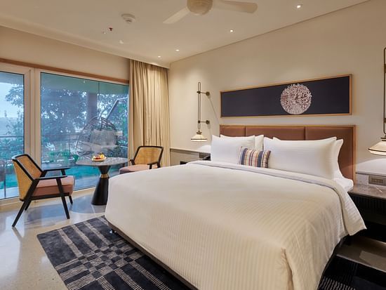  Image of a room with a king size bed and large windows on the side at The Dukes Retreat.