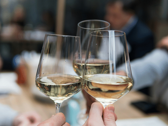 Three champagne glasses clinking in cheers