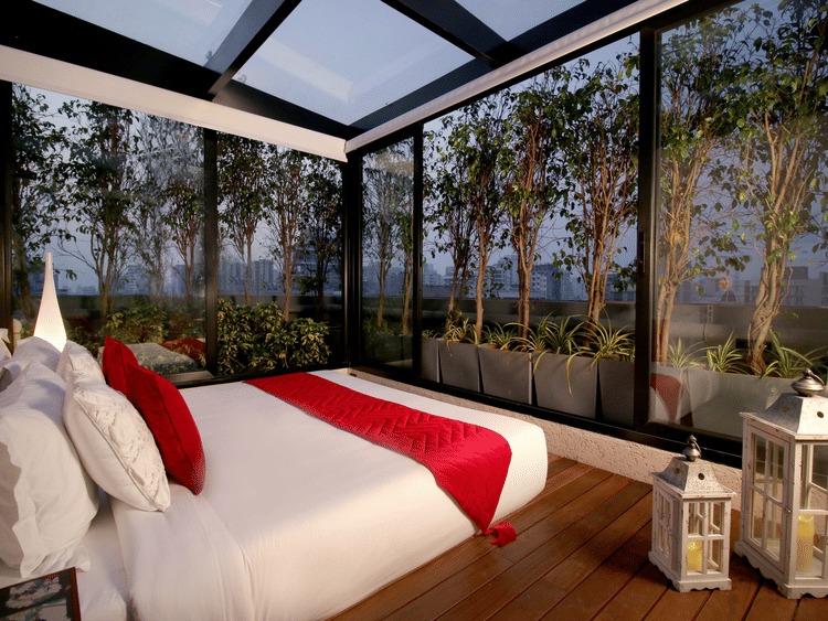 a cosy bedroom with glass windows