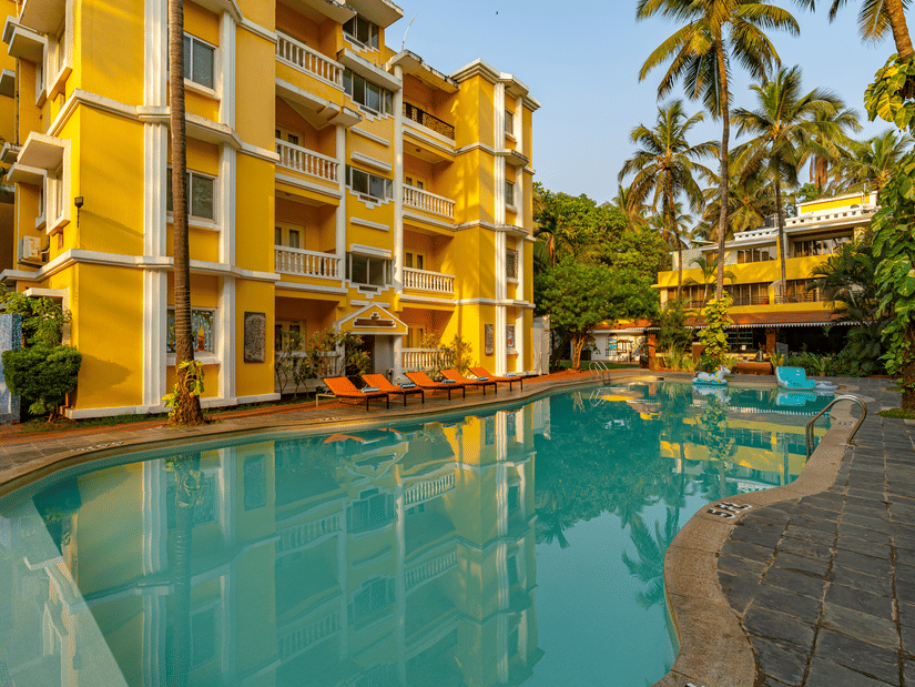The pool of the hotel surrounded by the hotel building.