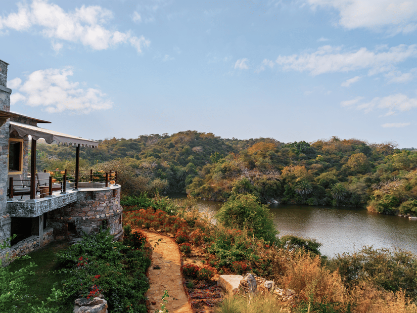 Side facade view of Chunda Shikar Oudi with the forest and lake surrounding it - Chunda Shikar Oudi.