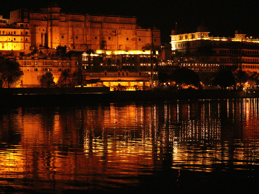 An overview of the city palace as seen from a distance with a waterbody in front of it