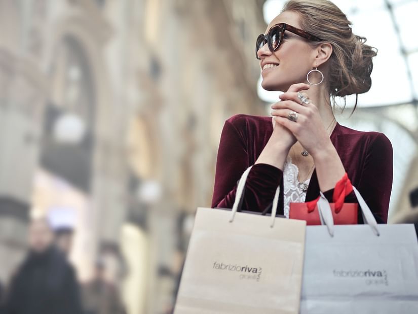 person holding shopping bags