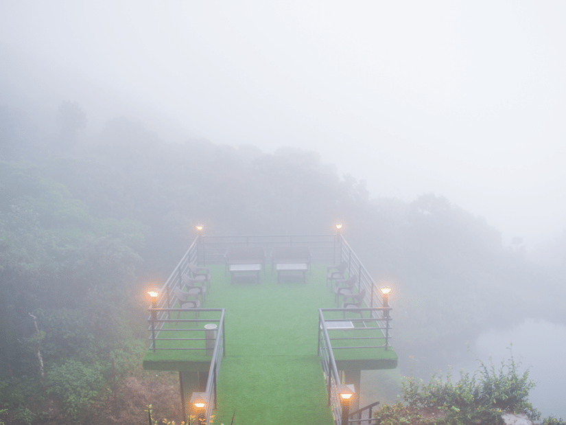 Shot of a private deck at the resort covered in mist overlooking the mountains | Ibex Stays and Trails
