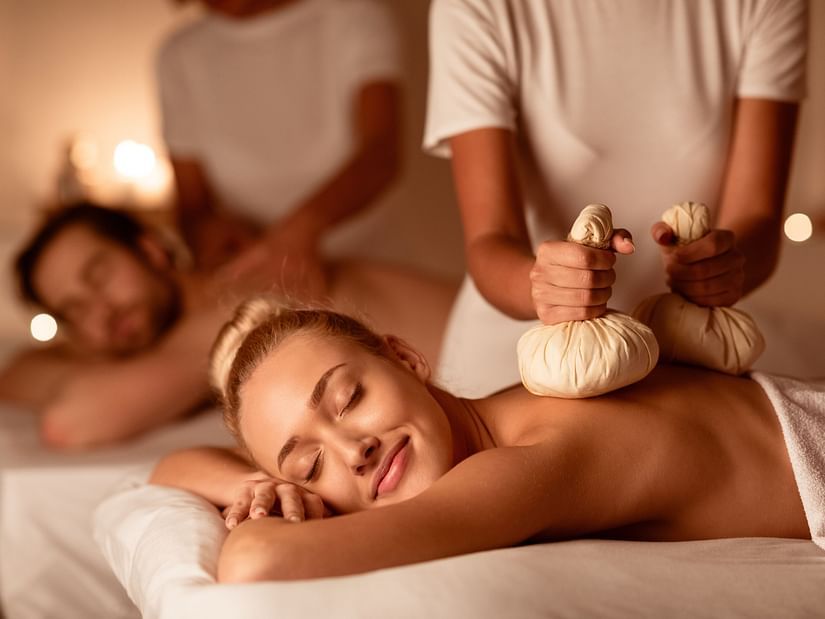 Image of a woman and a man in a spa getting massages