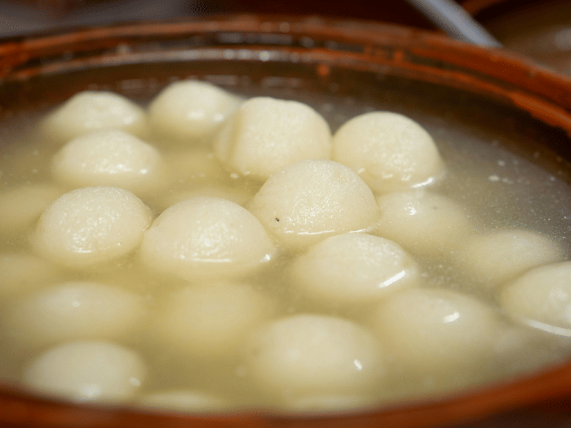 Bengali rosogollas dipped in sugar syrup in an earthen container