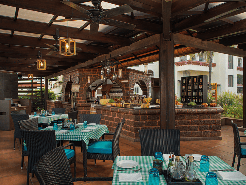 Due Amici, an Italian restaurant with its outdoor seating facility in view at Kenilworth Resort & Spa, Goa, perfect for dining on a corporate offsite in Goa